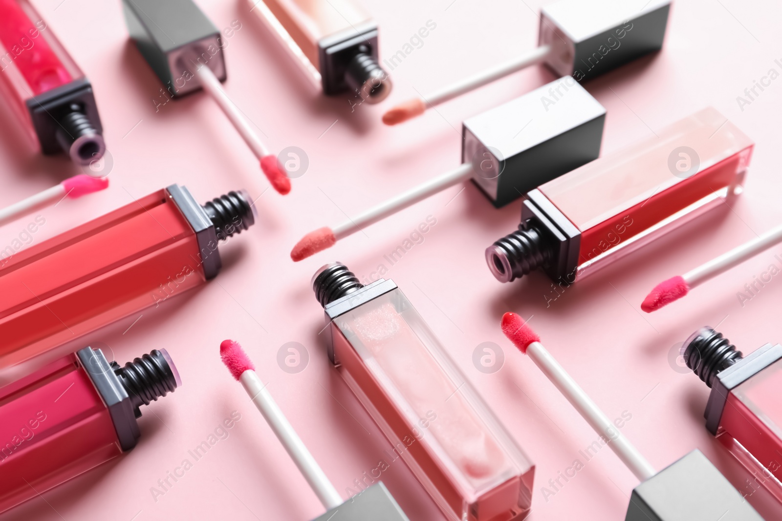 Photo of Composition of liquid lipsticks on color background