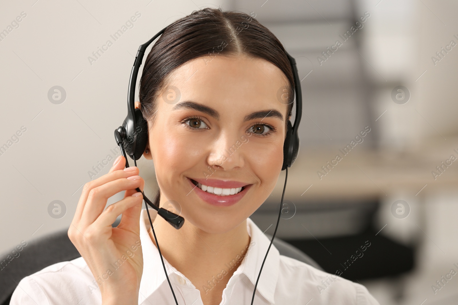 Photo of Hotline operator with headset working in office