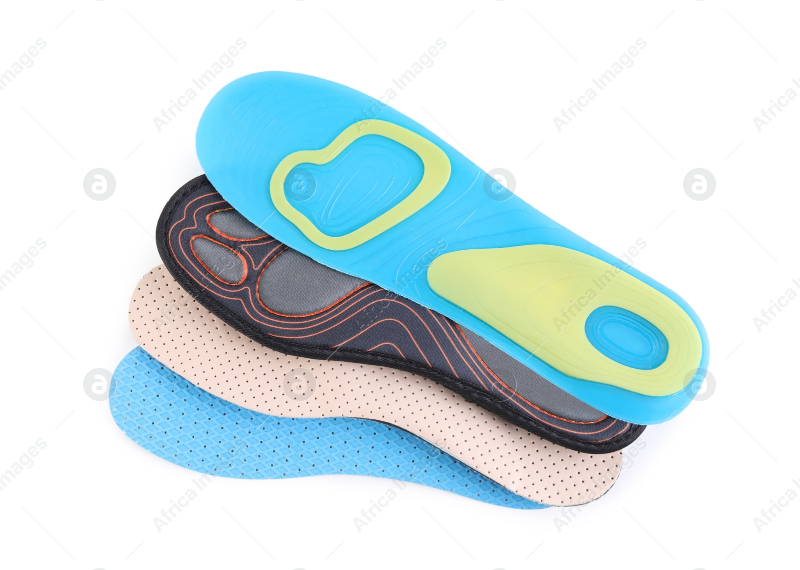 Photo of Four different shoe insoles on white background, top view