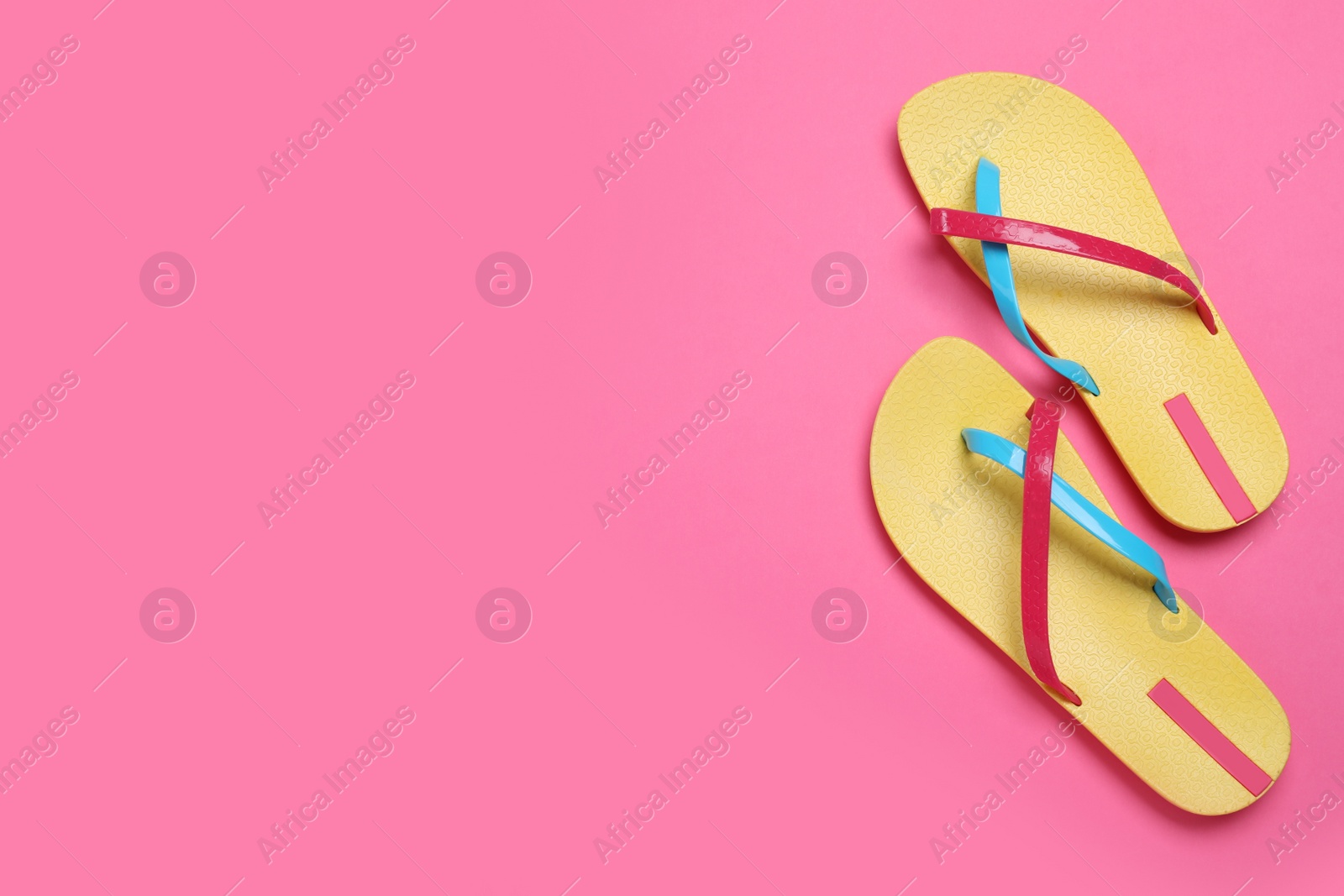 Photo of Stylish flip flops on pink background, flat lay. Space for text