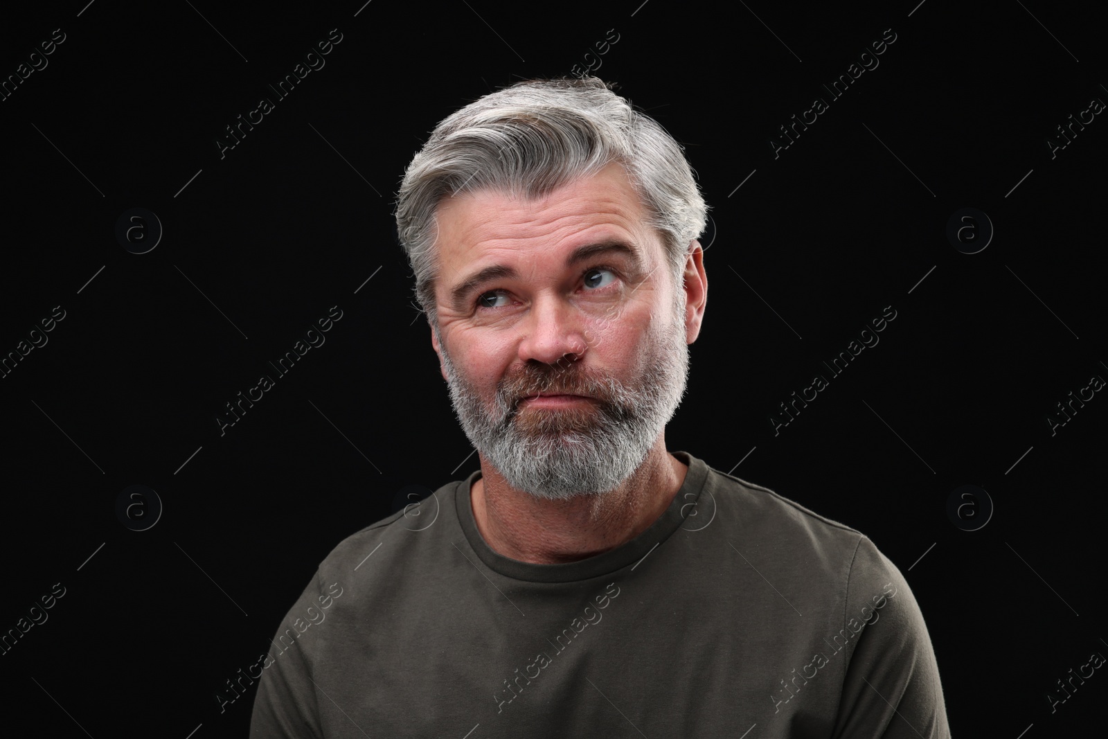 Photo of Personality concept. Portrait of sad man on black background
