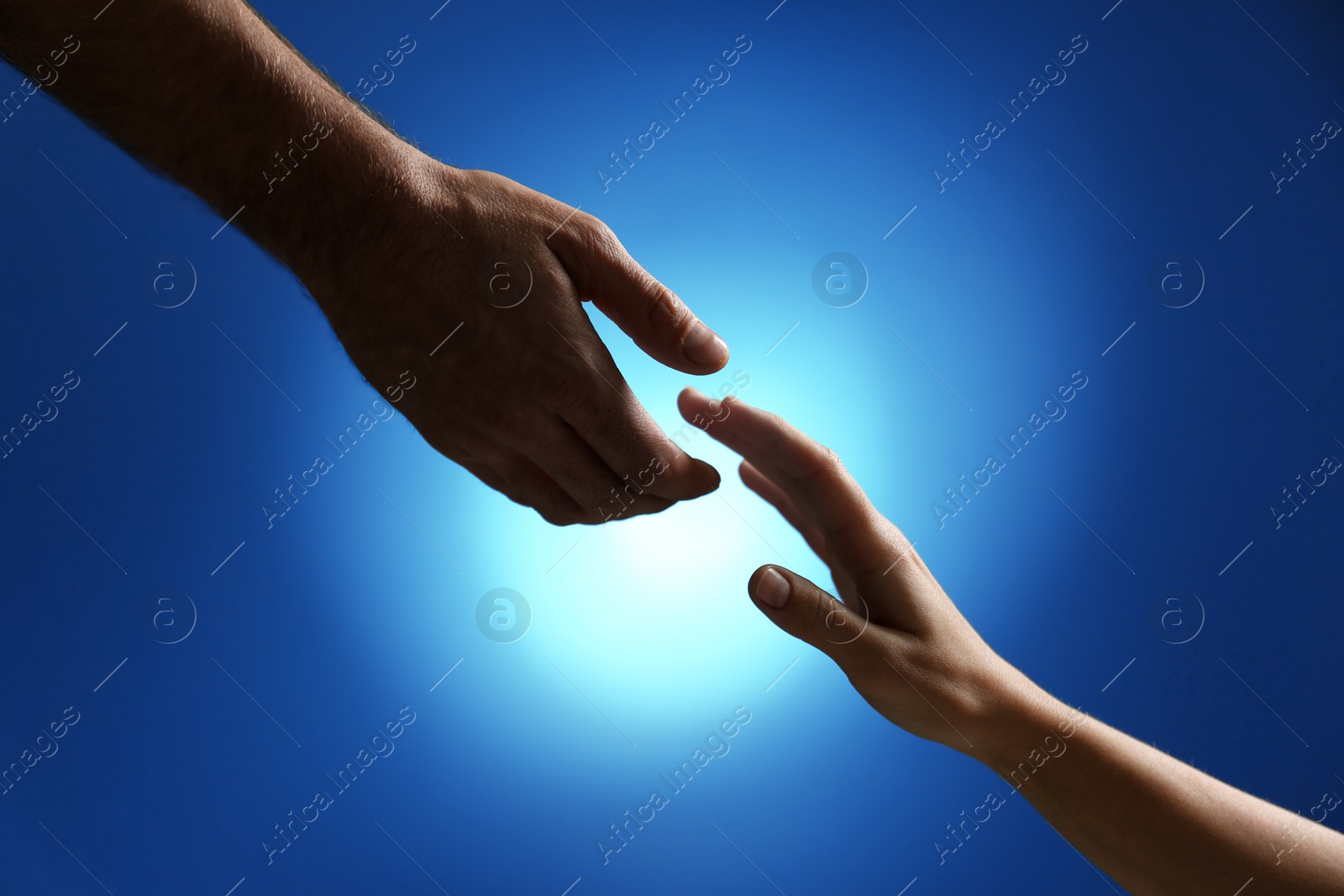 Photo of Man reaching for woman's hand on color background, closeup. Help and support concept