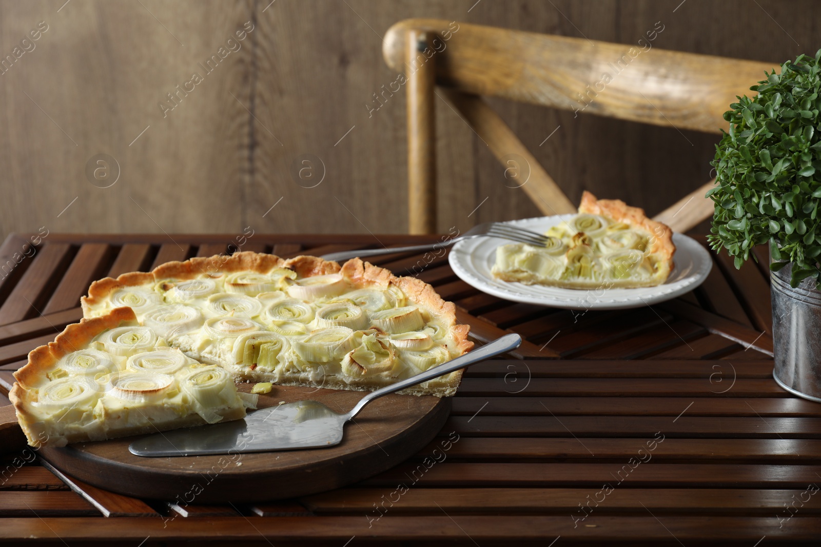 Photo of Tasty leek pie served on wooden table
