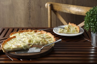 Tasty leek pie served on wooden table