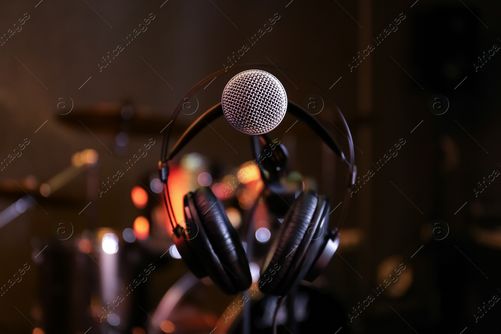Photo of Condenser microphone and headset in modern recording studio