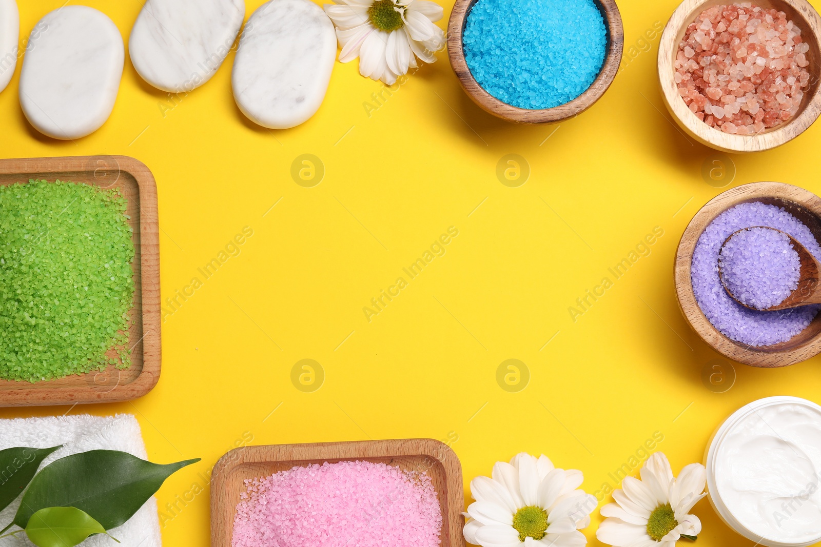 Photo of Flat lay composition with different sea salt on yellow background. Space for text