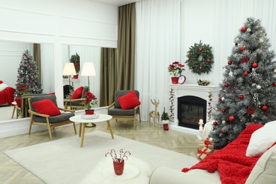 Beautiful living room interior with burning fireplace and Christmas tree