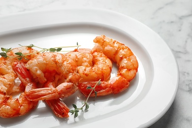 Photo of Plate with delicious fried shrimps on light background, closeup