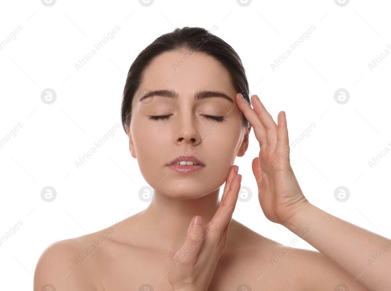 Photo of Young woman massaging her face on white background