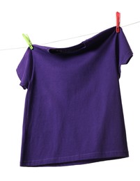 One purple t-shirt drying on washing line isolated on white