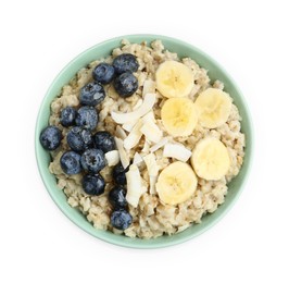 Tasty oatmeal with banana, blueberries and coconut flakes in bowl isolated on white, top view