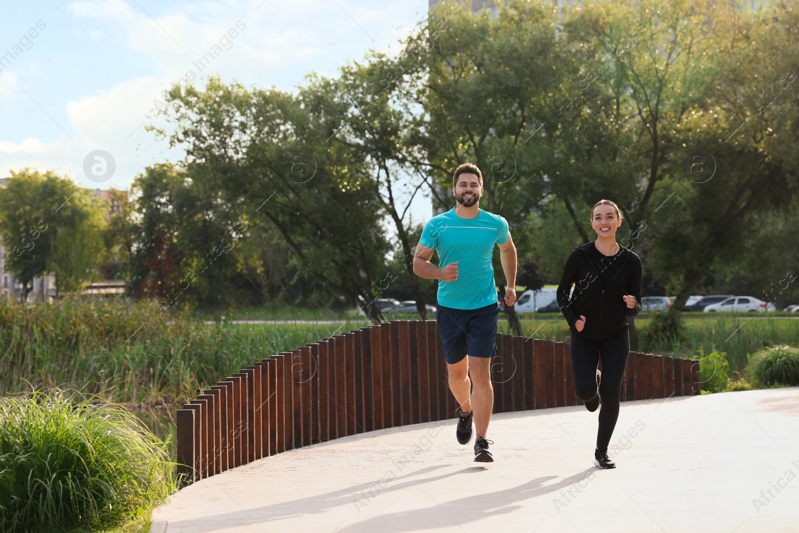 Photo of Healthy lifestyle. Happy couple running outdoors, space for text