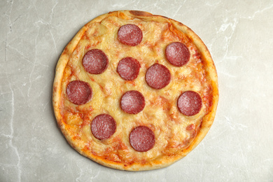 Photo of Tasty pepperoni pizza on light grey marble table, top view