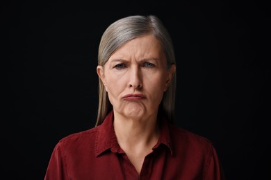 Photo of Personality concept. Portrait of emotional woman on black background