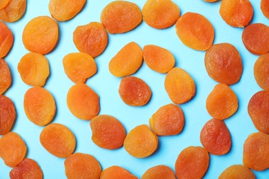 Photo of Flat lay composition with dried apricots on  color background. Healthy fruit