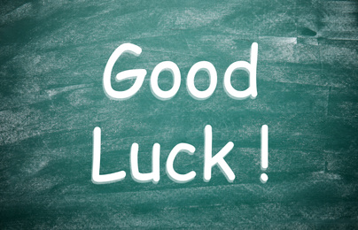 Image of Phrase GOOD LUCK on dirty green chalkboard