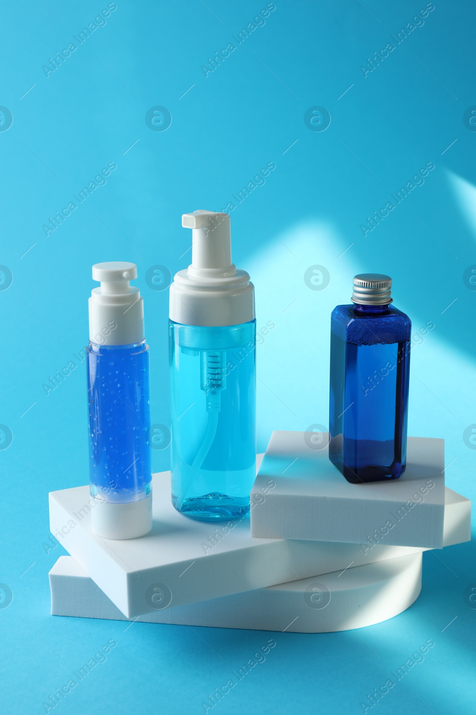 Photo of Set of luxury cosmetic products on light blue background