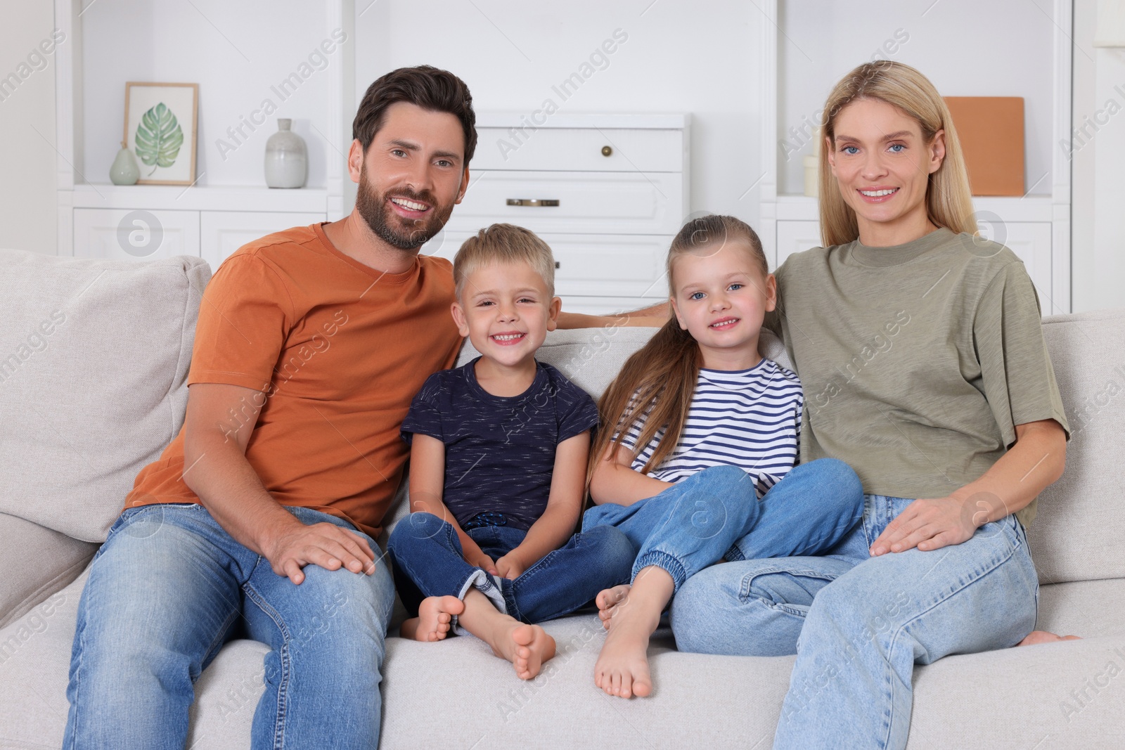 Photo of Portrait of happy family with children on sofa at home