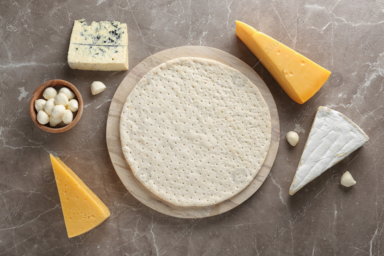 Photo of Flat lay composition with pizza crust and fresh ingredients on table