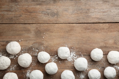 Snowballs on wooden background, flat lay. Space for text