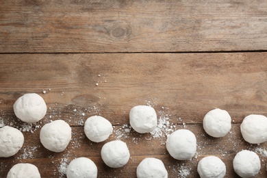 Photo of Snowballs on wooden background, flat lay. Space for text