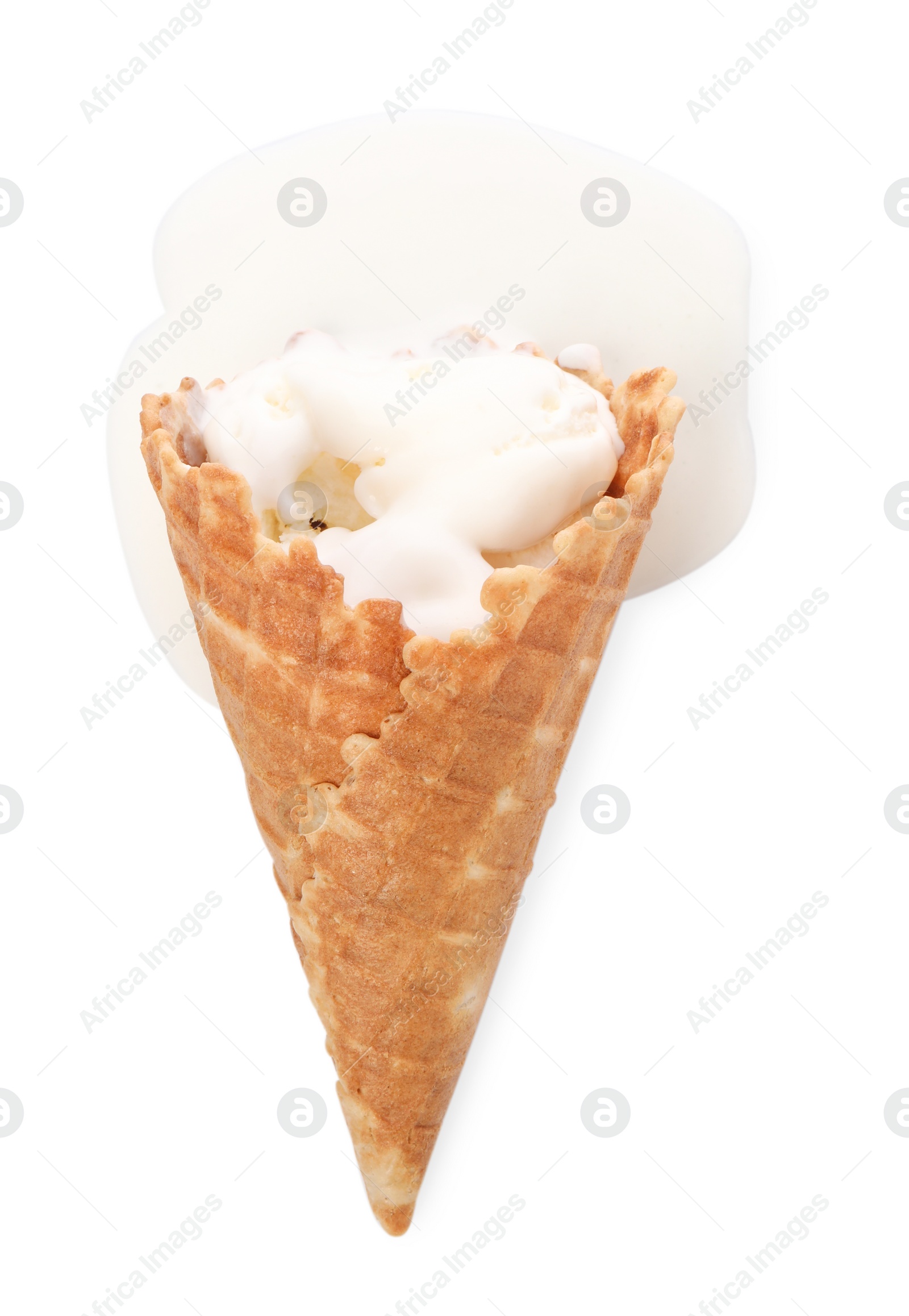 Photo of Melting ice cream in wafer cone isolated on white, top view