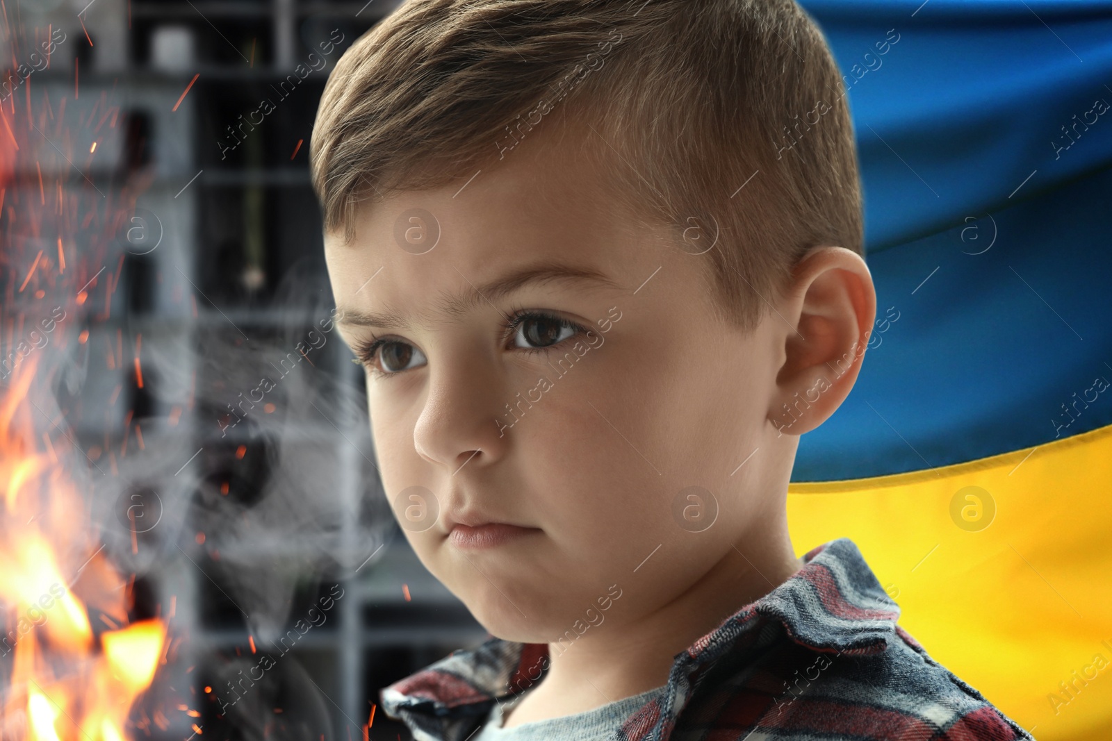 Image of Sad little boy, national flag and fire. Stop war in Ukraine