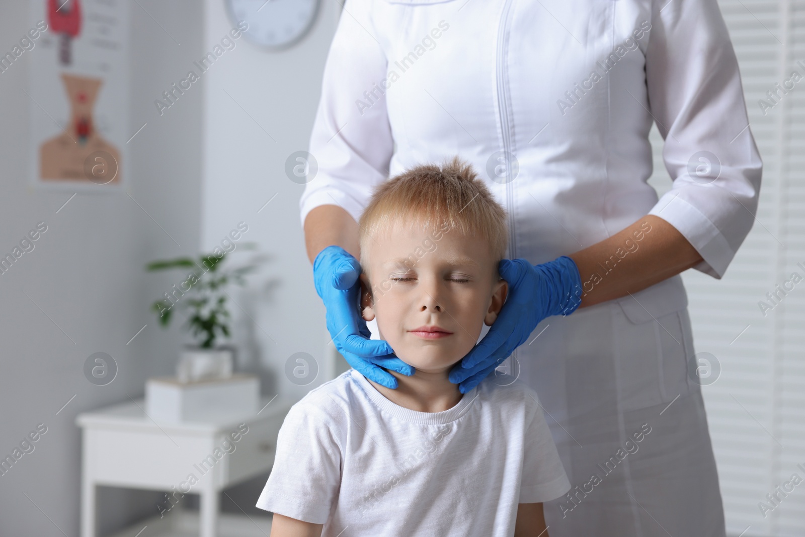 Photo of Endocrinologist examining thyroid gland of patient at hospital, closeup