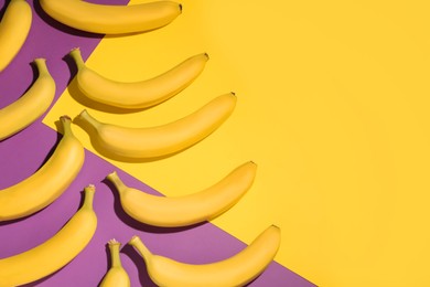 Ripe yellow bananas on color background, flat lay. Space for text