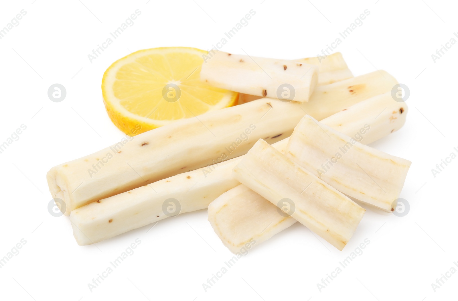 Photo of Cut raw salsify roots and lemon isolated on white