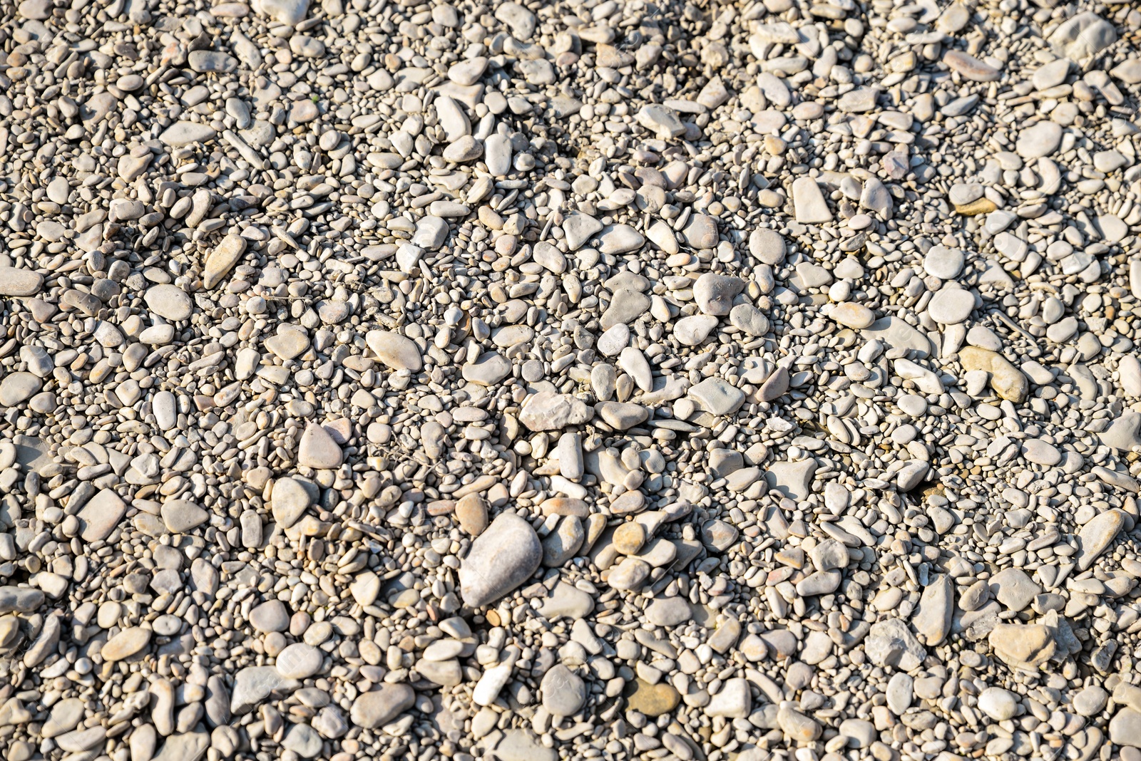 Photo of Ground covered with stones and pebbles as background