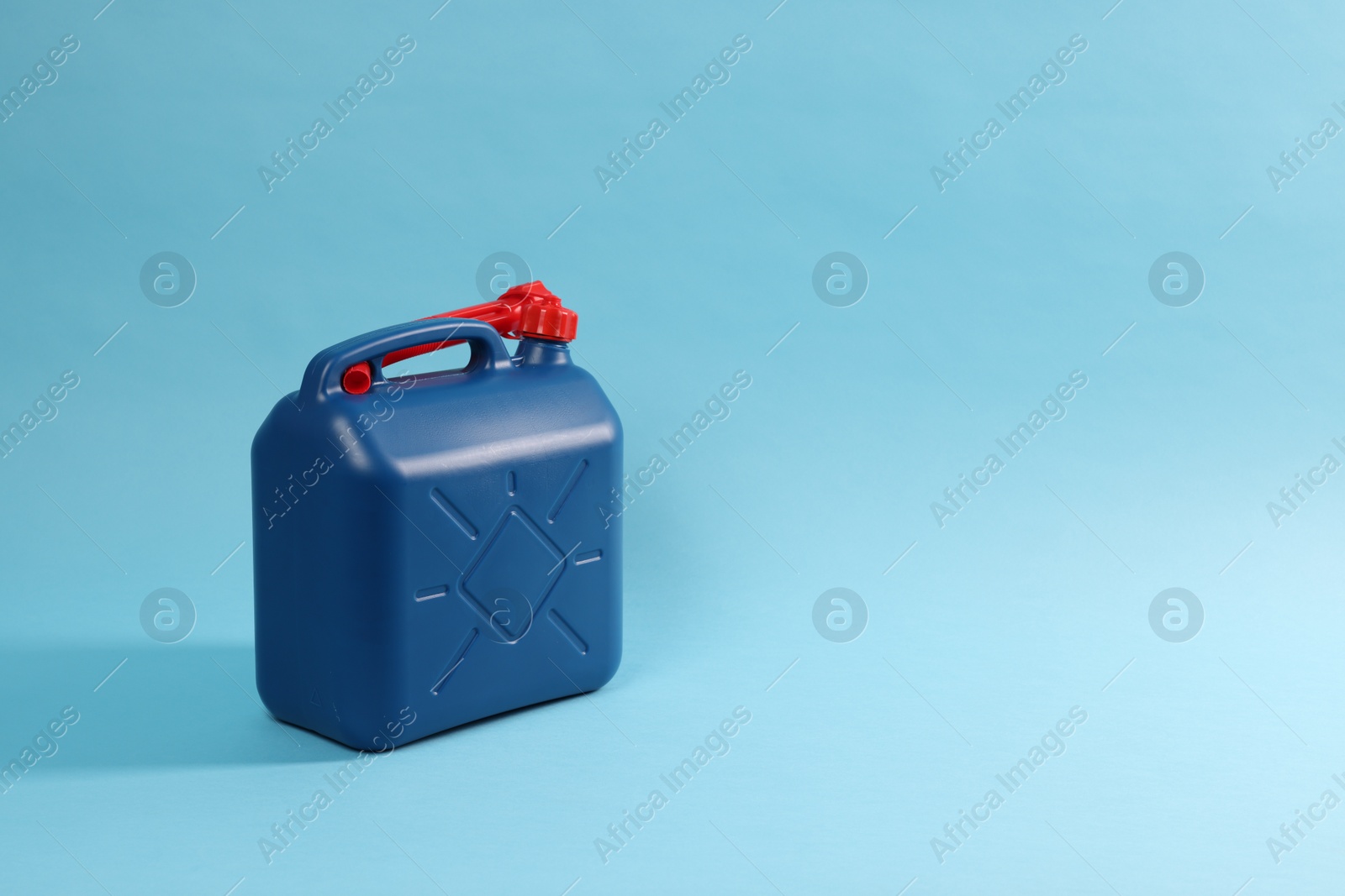 Photo of New plastic canister on light blue background. Space for text