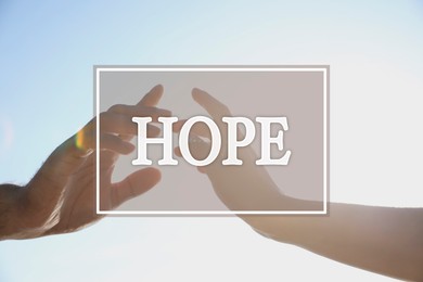 Image of Concept of hope. Man and woman reaching hands to each other, closeup
