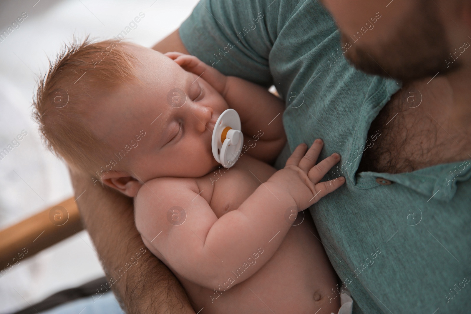 Photo of Father with his newborn son, closeup view