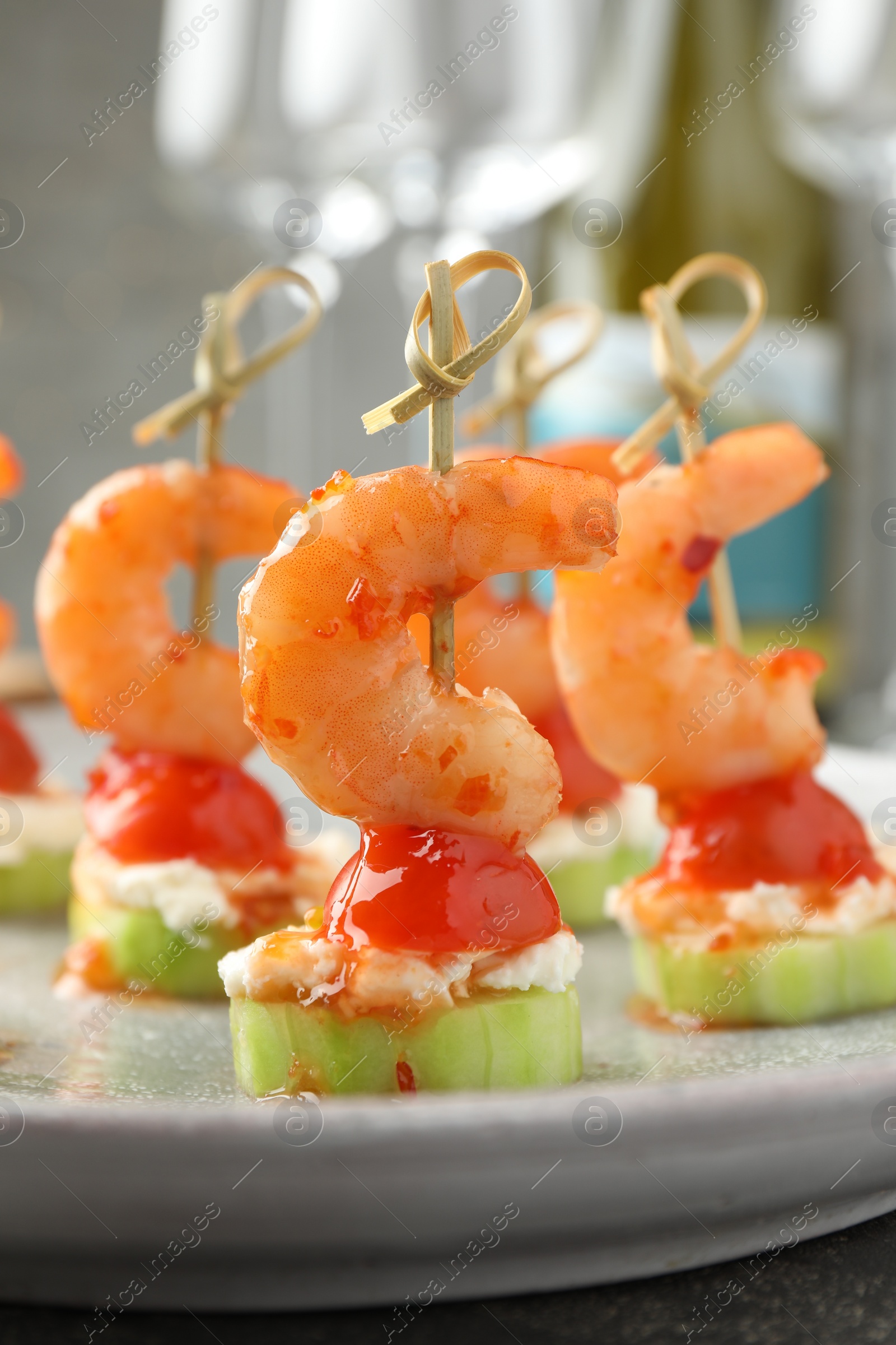 Photo of Tasty canapes with shrimps, vegetables and cream cheese on table, closeup