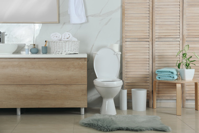 Photo of Stylish toilet bowl in modern bathroom interior