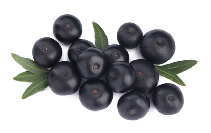 Pile of fresh ripe acai berries and green leaves on white background, top view