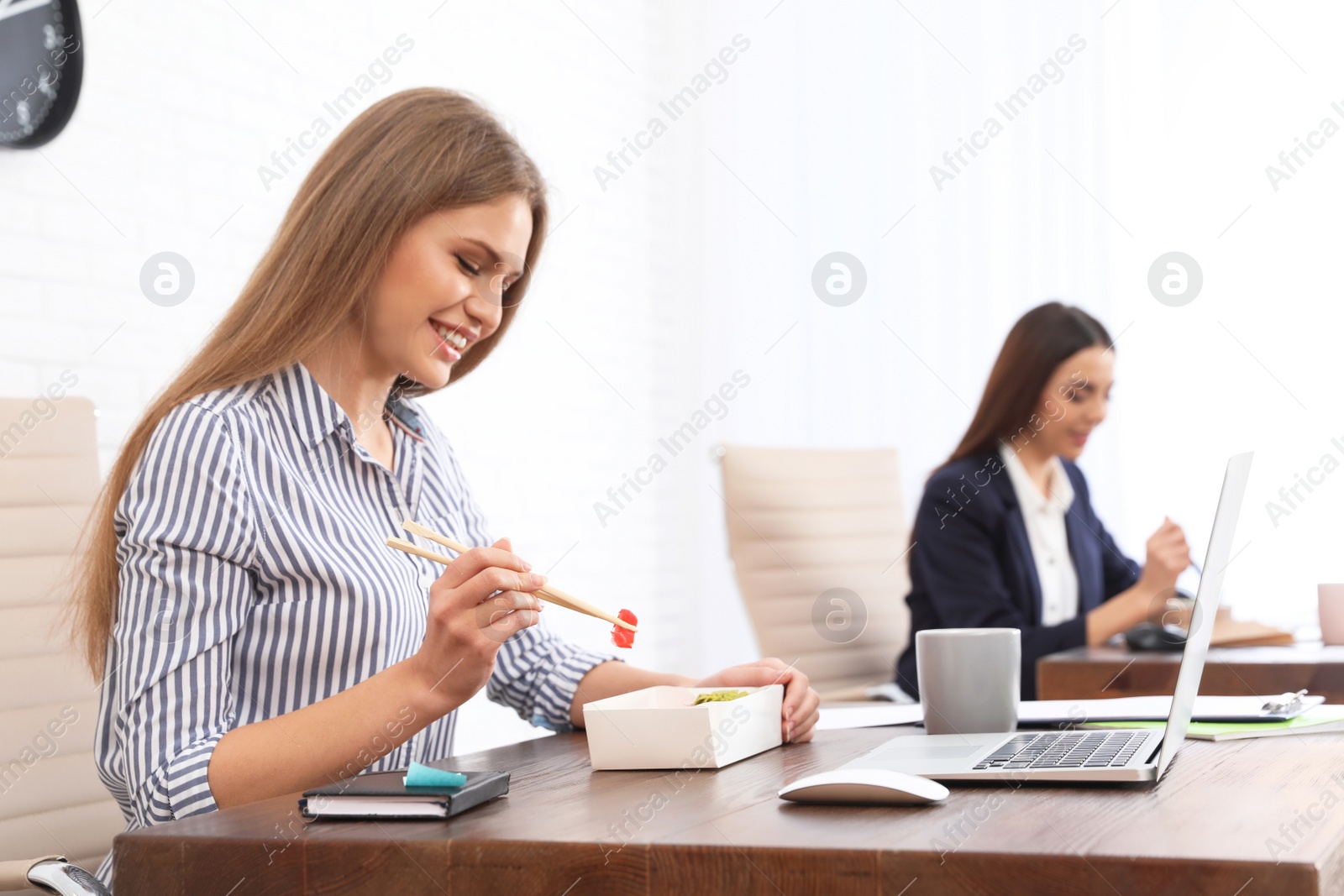 Photo of Office employees having lunch at workplace. Food delivery