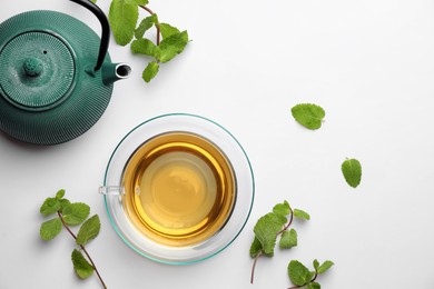 Photo of Aromatic herbal tea with mint on white table, flat lay. Space for text