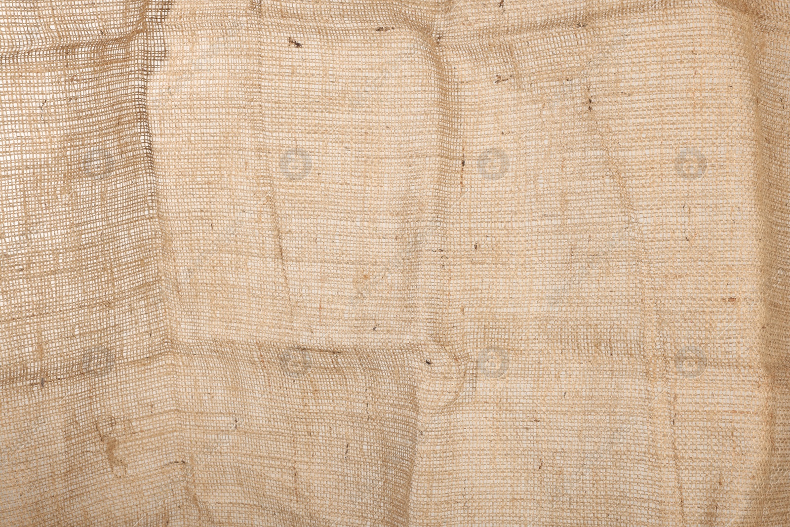 Photo of Texture of natural burlap fabric as background, closeup