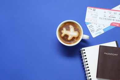 Photo of Flat lay composition with passport, cup of coffee and tickets on blue table, space for text. Business trip