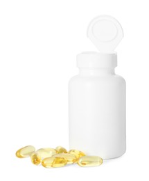 Bottle and pile of softgel capsules isolated on white