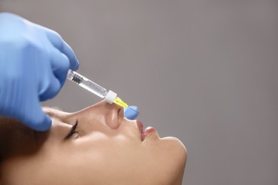 Photo of Beautiful woman getting lips injection in salon