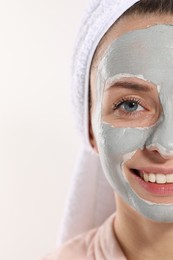Photo of Woman with face mask on white background, closeup and space for text. Spa treatments