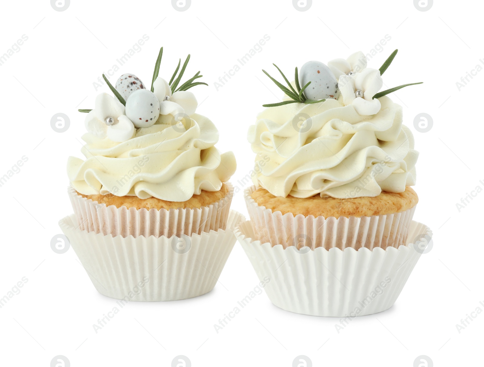 Photo of Tasty Easter cupcakes with vanilla cream isolated on white