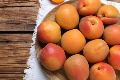 Delicious fresh ripe apricots on wooden table, top view