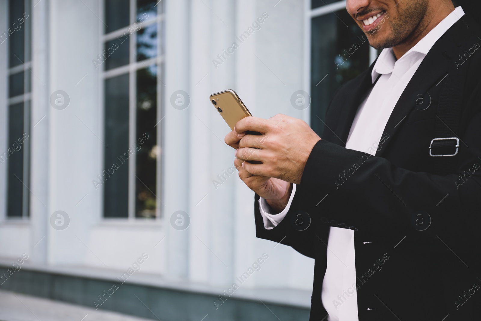 Photo of Man with smartphone on city street, closeup