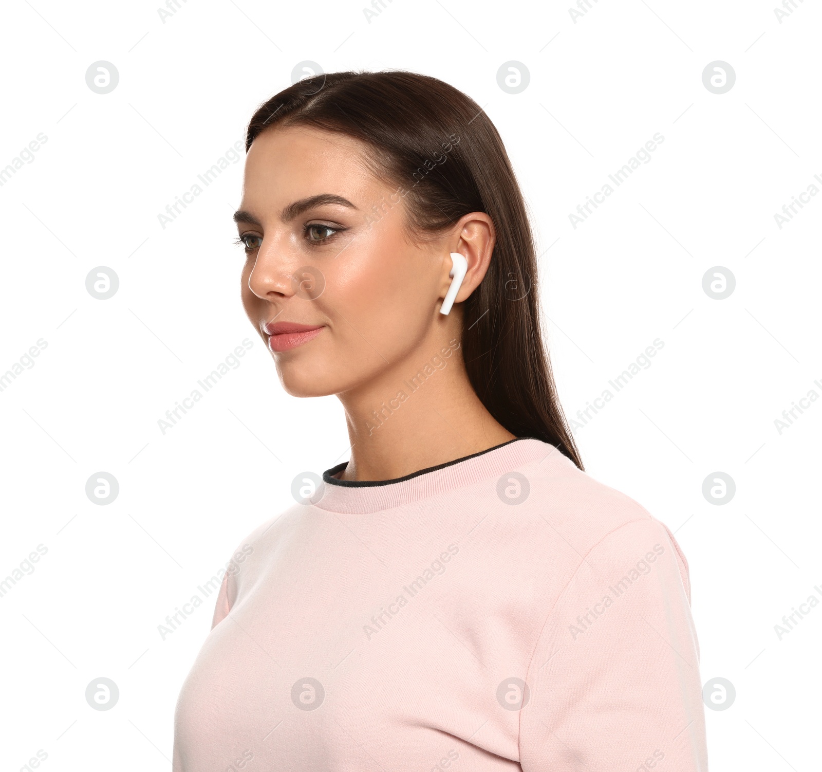Photo of Happy young woman listening to music through wireless earphones on white background