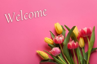 Image of Welcome card. Beautiful tulip flowers and word on pink background, top view