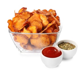 Bowl of sweet potato chips with sauce and herbs isolated on white